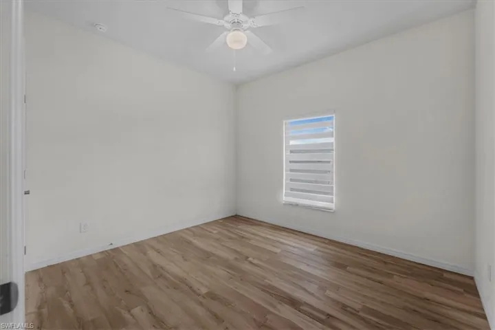 Unfurnished room with light wood finished floors and ceiling fan