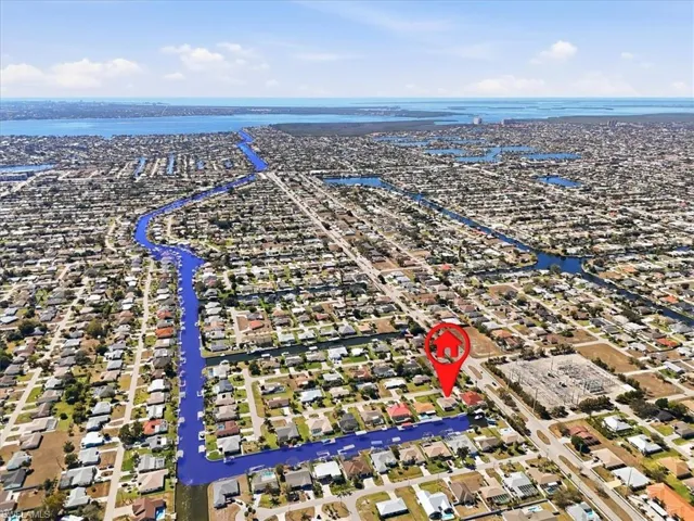 Aerial perspective of suburban area featuring a large body of water