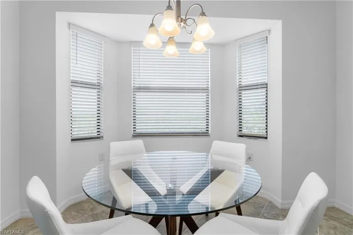 Dining space with an inviting chandelier and light tile patterned floors