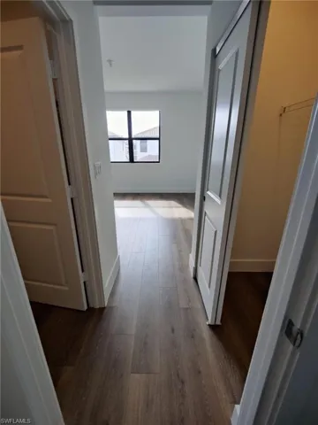 Corridor with dark wood-type flooring