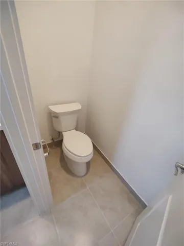 Bathroom featuring tile patterned floors and toilet