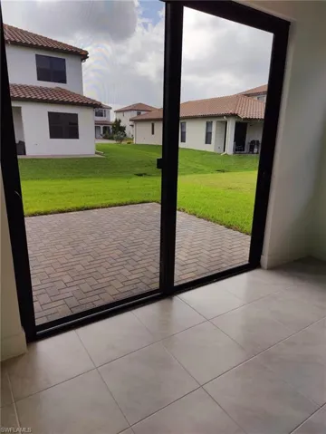 Doorway to outside with light tile patterned floors
