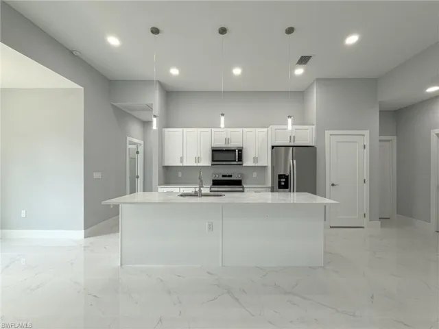 Unfurnished room featuring visible vents, ceiling fan, marble finish floor, and baseboards