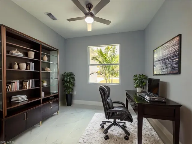 Office with ceiling fan, visible vents, baseboards, and marble finish floor