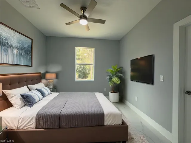 2nd Bedroom with baseboards, visible vents, ceiling fan, and marble finish floor
