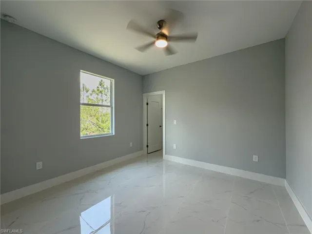 3rd Bedroom with ceiling fan, marble finish floor, and baseboards