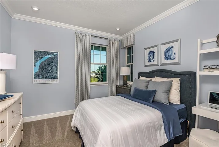 Carpeted bedroom featuring baseboards and ornamental molding