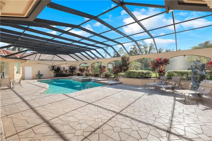 Pool view from family room. Spacious deck displays lounge seating area on the right