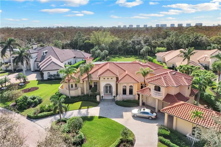 Aerial exhibits large back & side yards plus condominiums on the beach in background!