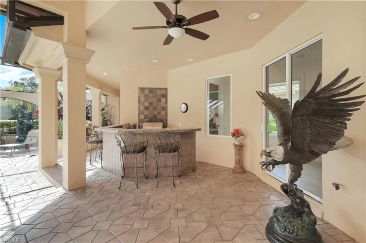 Lanai walk-in bar seats 4-5 and has a built in grill w/backsplash, sink and refrigerator!