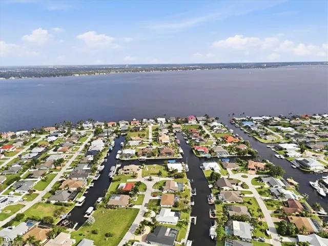 Aerial perspective showcasing a waterfront community with direct access to a large body of water