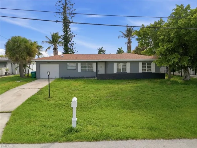 Single-story residence featuring a two-tone exterior, white window shutters, and a brown shingle roof