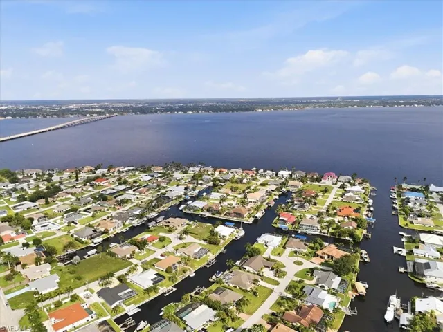 Aerial perspective showcasing a waterfront community with direct canal access to a large body of water