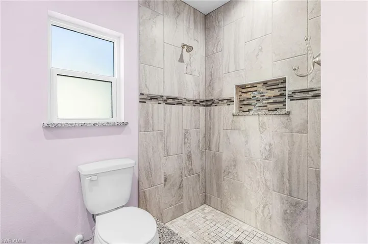 Full bath with a tile shower