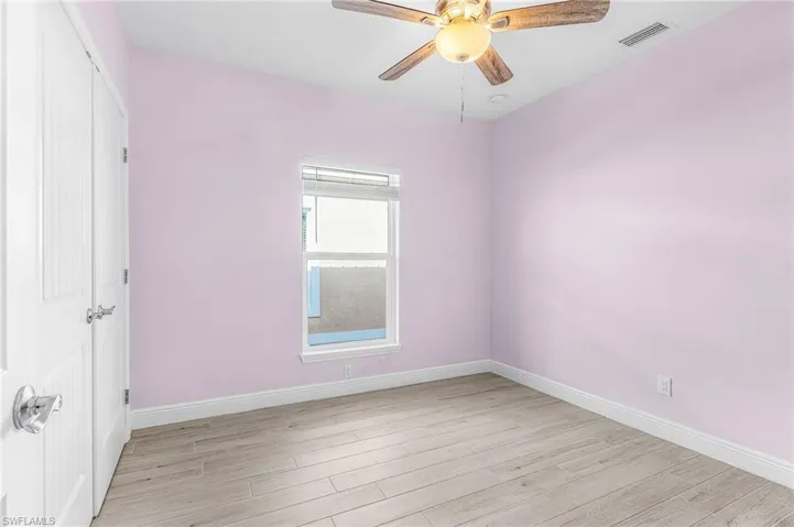 Unfurnished room featuring light wood-style floors and a ceiling fan