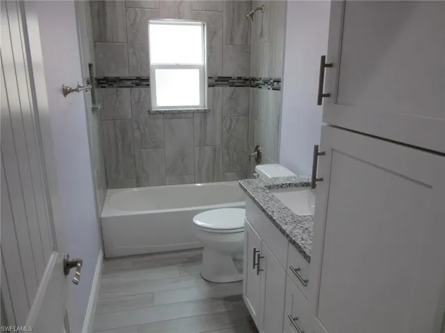 Full bathroom with vanity and shower / bath combination