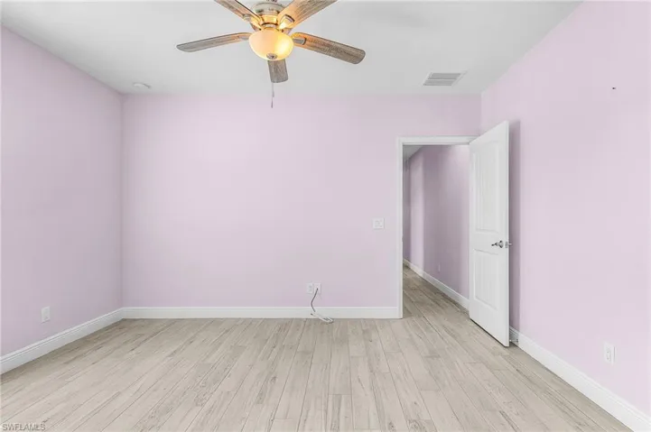 Spare room with light wood-style flooring and a ceiling fan