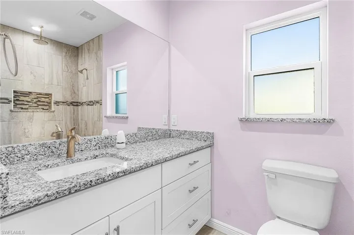 Full bathroom with vanity and a tile shower