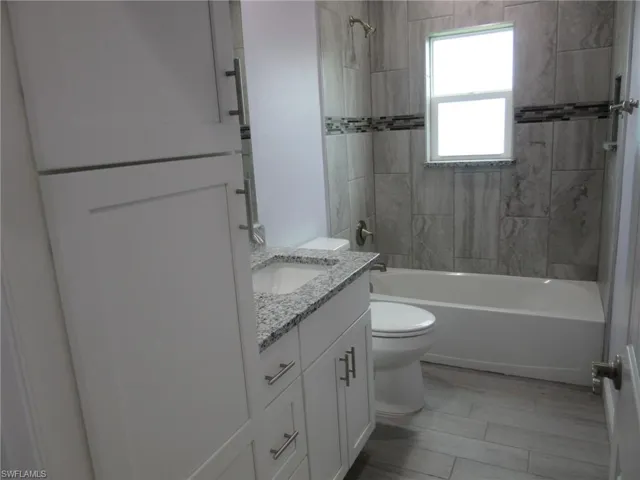 Bathroom featuring vanity and  shower combination