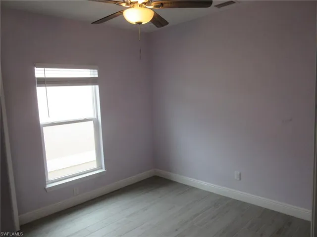 Spare room featuring ceiling fan and light wood-style flooring