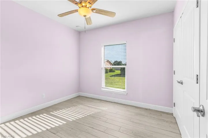 Unfurnished room featuring light wood finished floors and ceiling fan