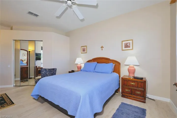 Bedroom featuring a ceiling fan and a closet