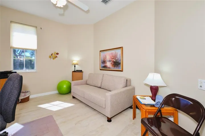 Office with baseboards and ceiling fan