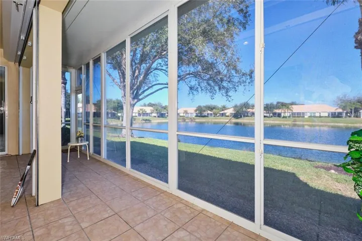 Unfurnished sunroom with a residential view and a water view