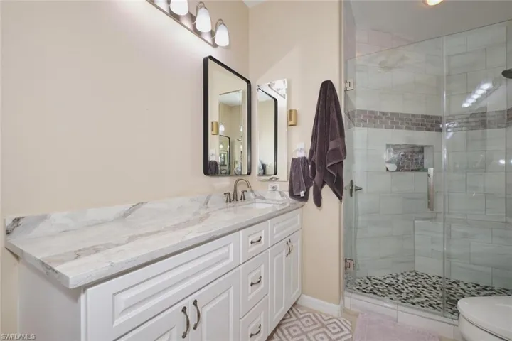 Full bathroom featuring a shower stall and vanity