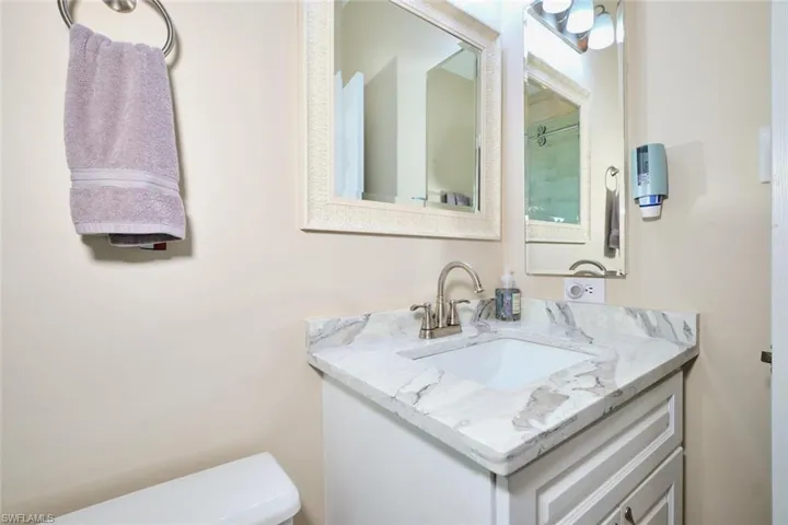 Half bathroom with vanity and toilet