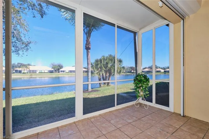 Unfurnished sunroom with a water view and a residential view