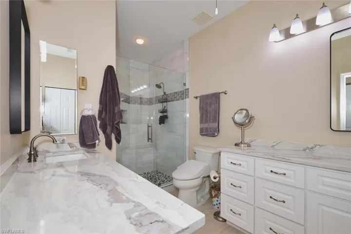 Full bathroom featuring vanity and a stall shower