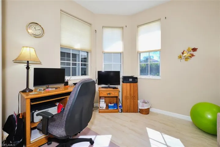 Office area featuring baseboards and wood finished floors