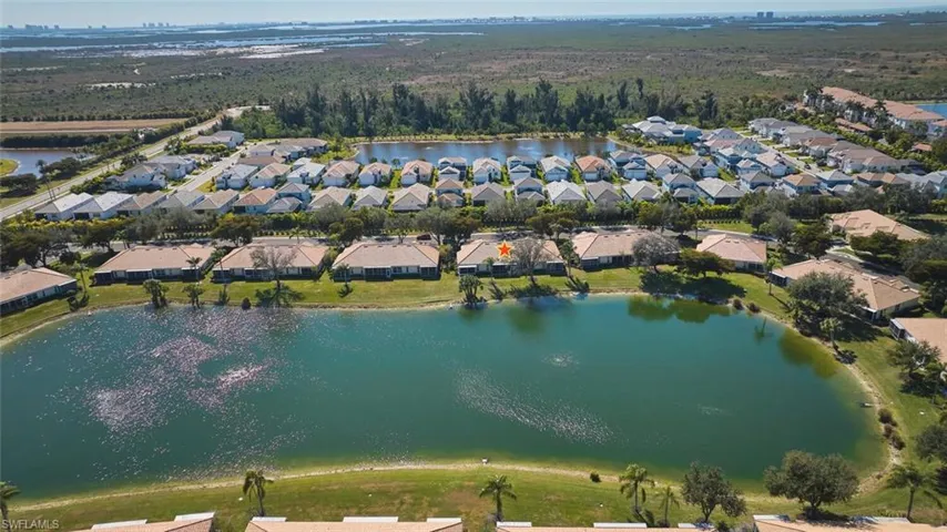 Aerial view of property's location featuring nearby suburban area and a nearby body of water