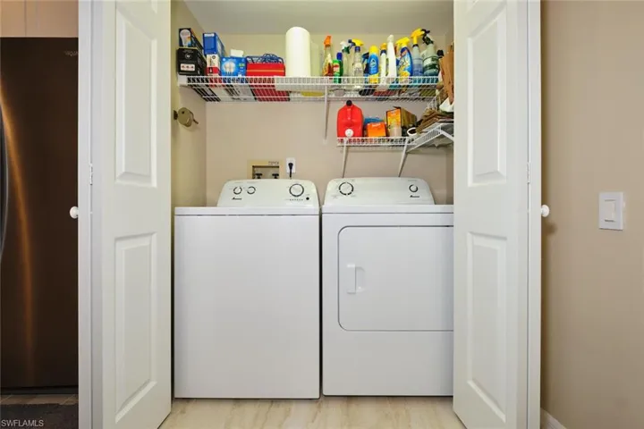 Laundry area featuring separate washer and dryer and light wood-style flooring