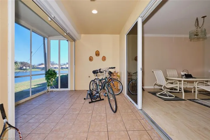Sunroom featuring a water view