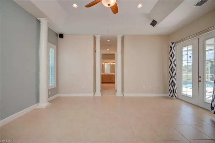 Unfurnished room featuring decorative columns, french doors, recessed lighting, and healthy amount of natural light