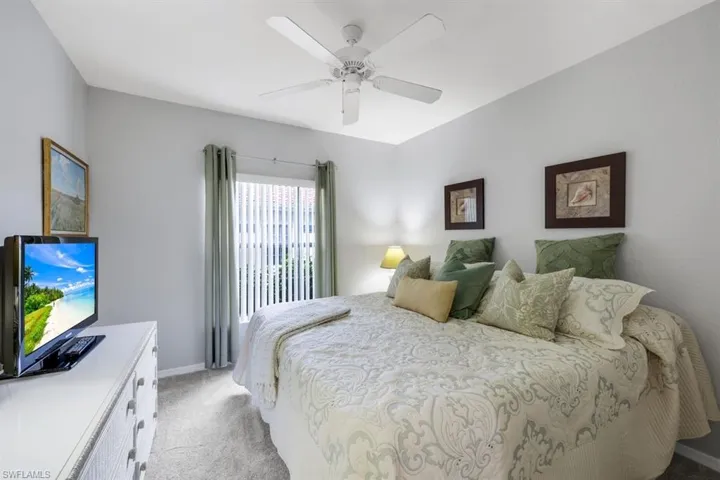 Bedroom with light carpet and ceiling fan