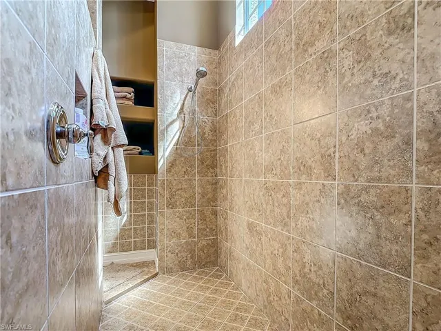 Full bath featuring a tile shower
