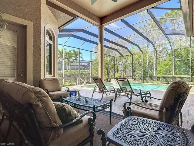 View of patio with outdoor lounge area, a lanai, and an outdoor pool