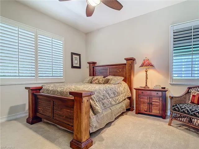 Bedroom featuring a ceiling fan and carpet flooring