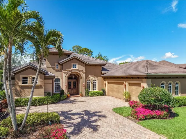 Mediterranean / spanish-style home with a garage, a tiled roof, decorative driveway, and stucco siding