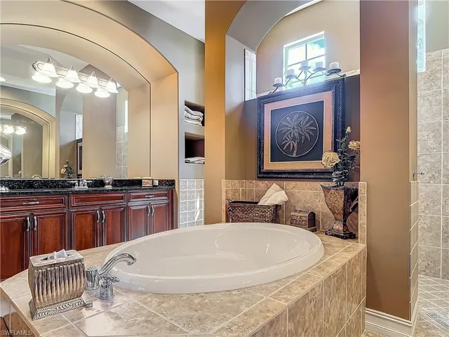 Bathroom with vanity and a bath