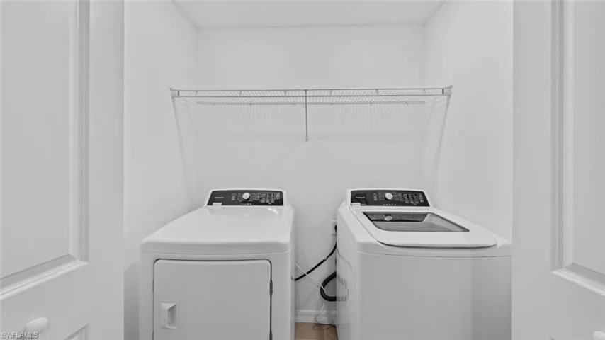 Convenient second-floor laundry room with full-size washer and dryer.