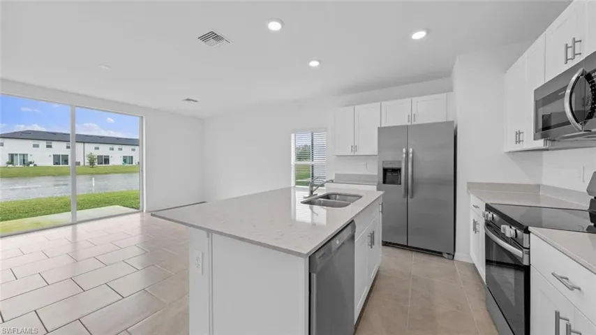 Bright kitchen with lake views and ample counter space.