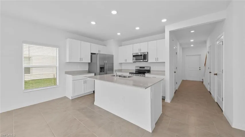 Open-concept kitchen overlooking the living and dining areas.
