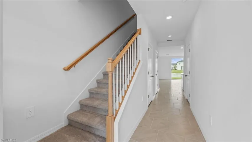 Welcoming entry with staircase leading to the second floor.