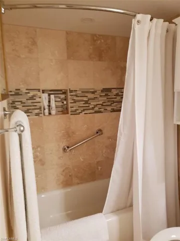 Pre Ian Bathroom featuring shower / bath combination with curtain