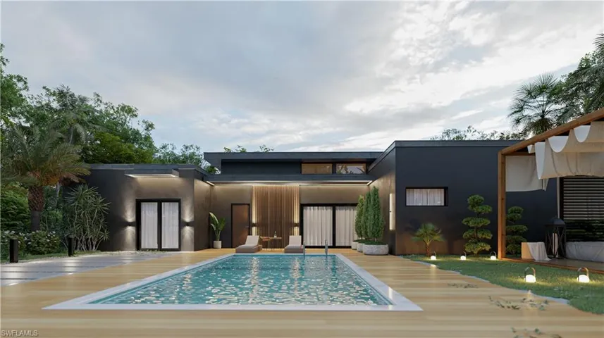 Rear view of house featuring stucco siding and a wooden deck