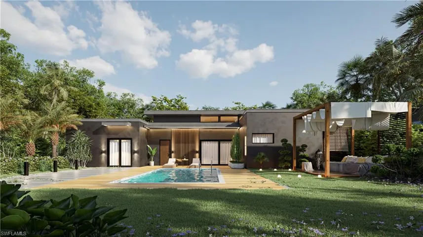 Back of house featuring stucco siding, a lawn, a patio area, and an outdoor pool